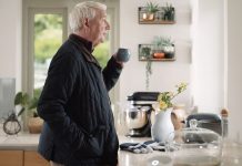 “Silent Days” Epidemic: Hundreds of Thousands of Older People Face Loneliness Older person holding mug looking out of window